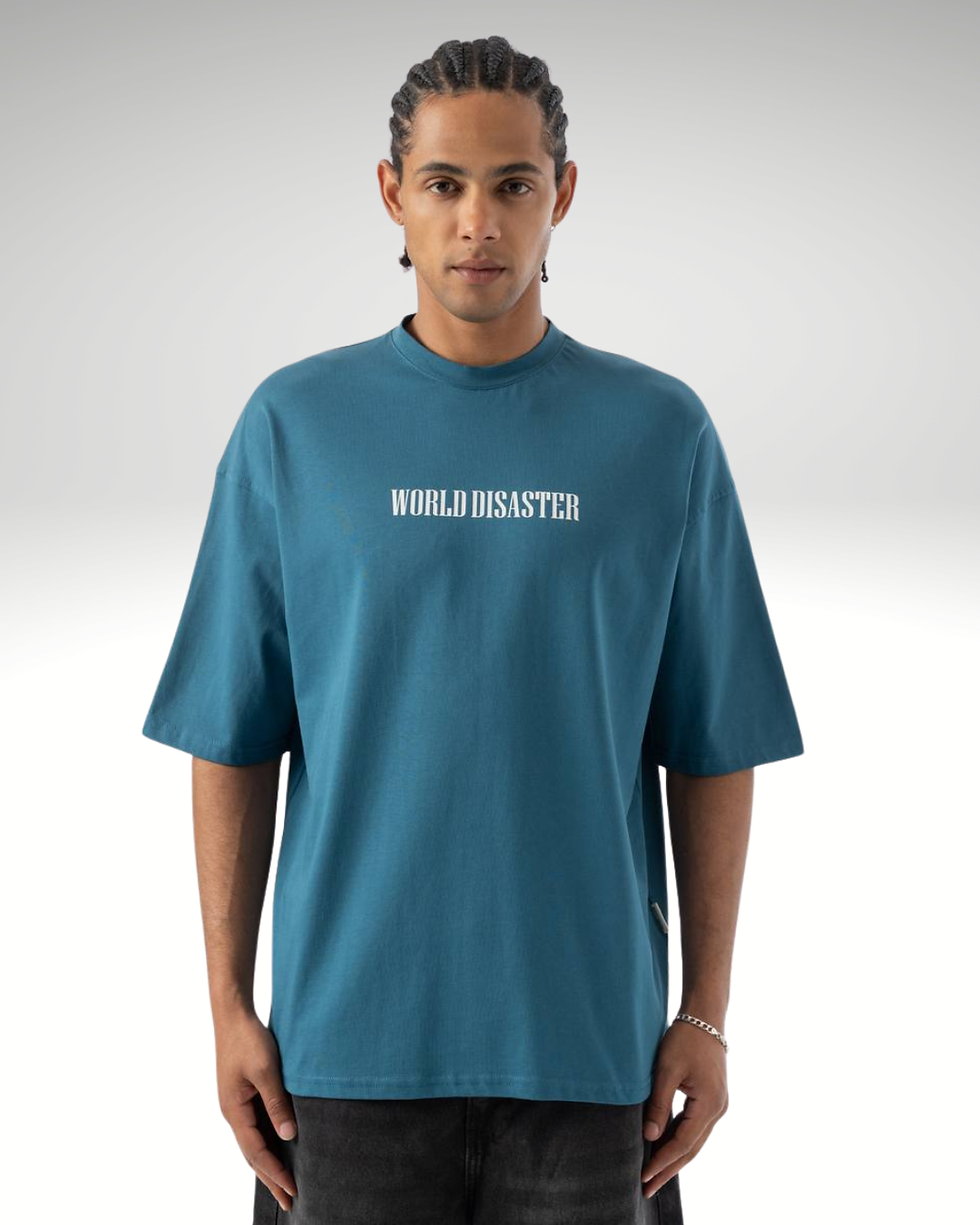 The Turquoise World Disaster Graphic T-Shirt is built to stand out and make a statement. Featuring “World Disaster” text on t