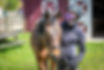 Woman wearing a Maryland Equestrian Club jacket and a riding hat standing next to a horse
