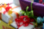 Colorful gift boxes with vibrant ribbons in red, yellow, and green. Close-up view, creating a festive and cheerful atmosphere.
