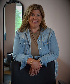 Natalie, Hairstylist leaning on a salon chair
