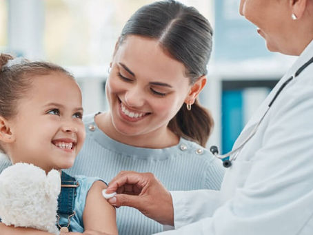Image shows a healthcare professional administering a vaccine to a young child.