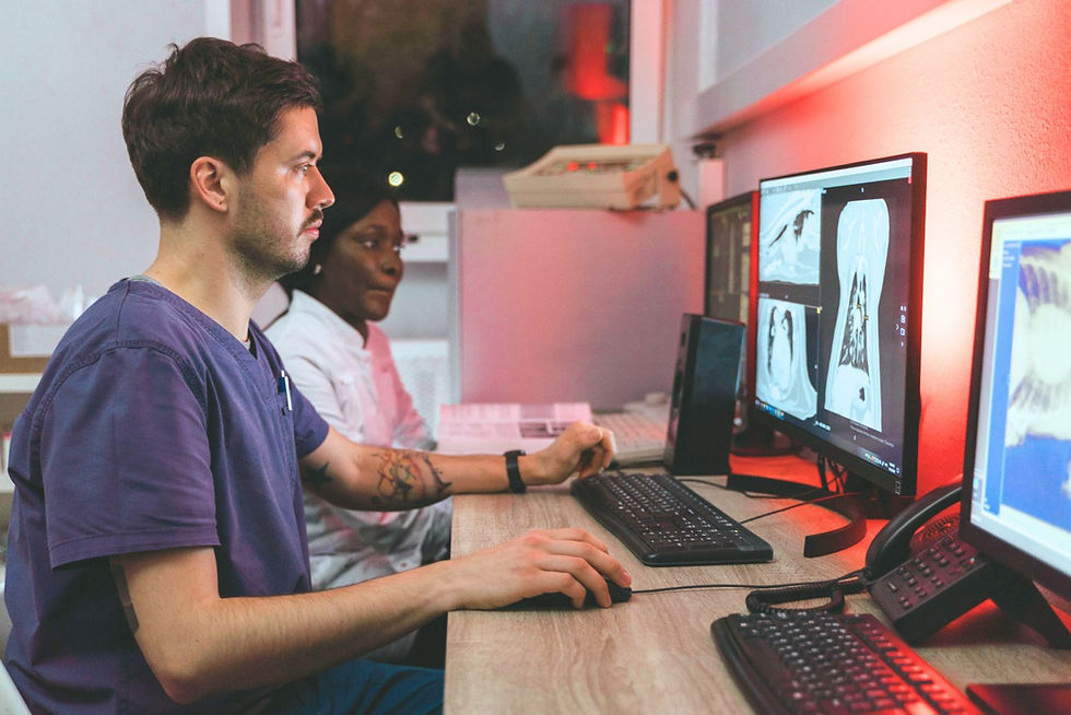 Two medical technicians viewing results on a monitor