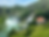 Viewpoint of beautiful waterfalls and a pretty colorful little house surrounded by green grass