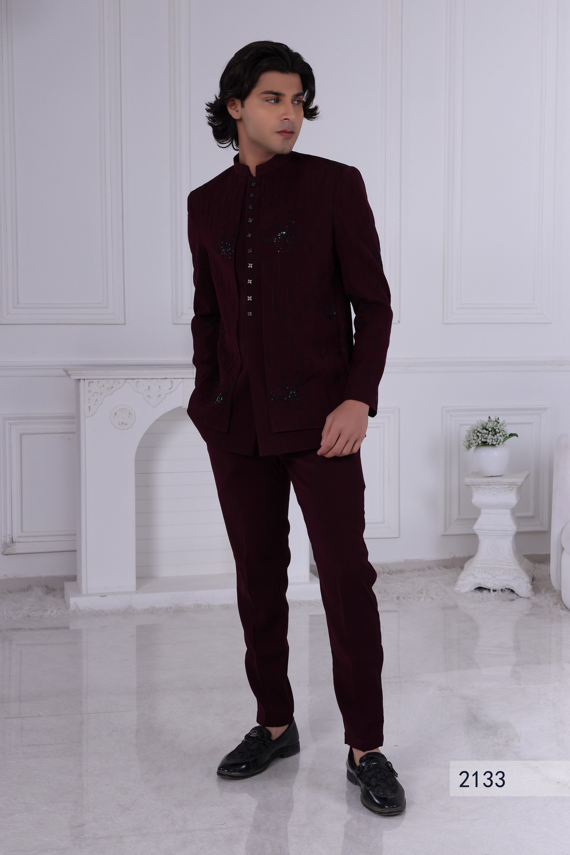 Man modeling a sophisticated 3-piece dark red Indo-Western suit for evening events, featuring a jacket with black beaded