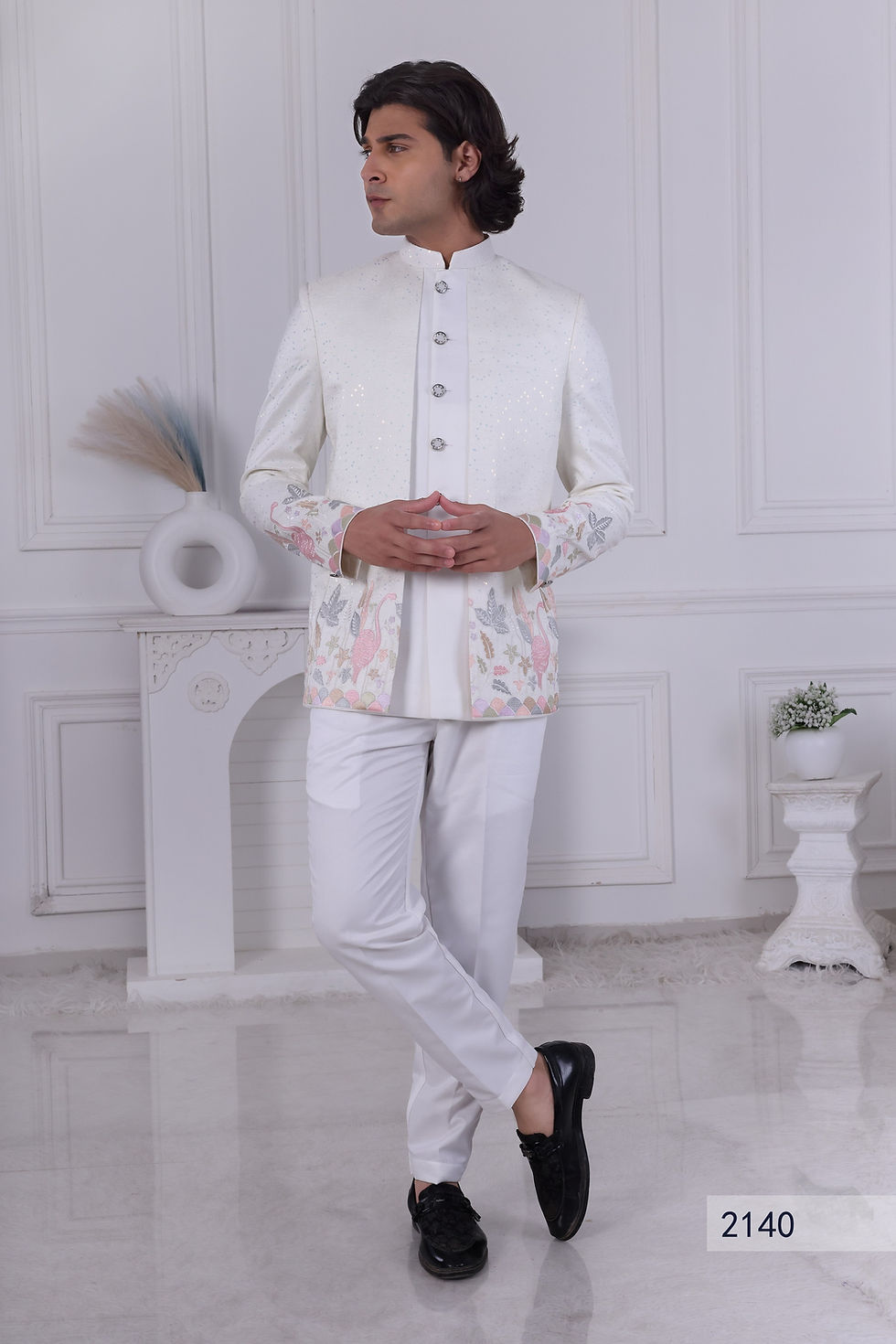 a unique 3-piece white Jodhpuri suit for a wedding, featuring a jacket with all-over shimmer sequins and an artistic border