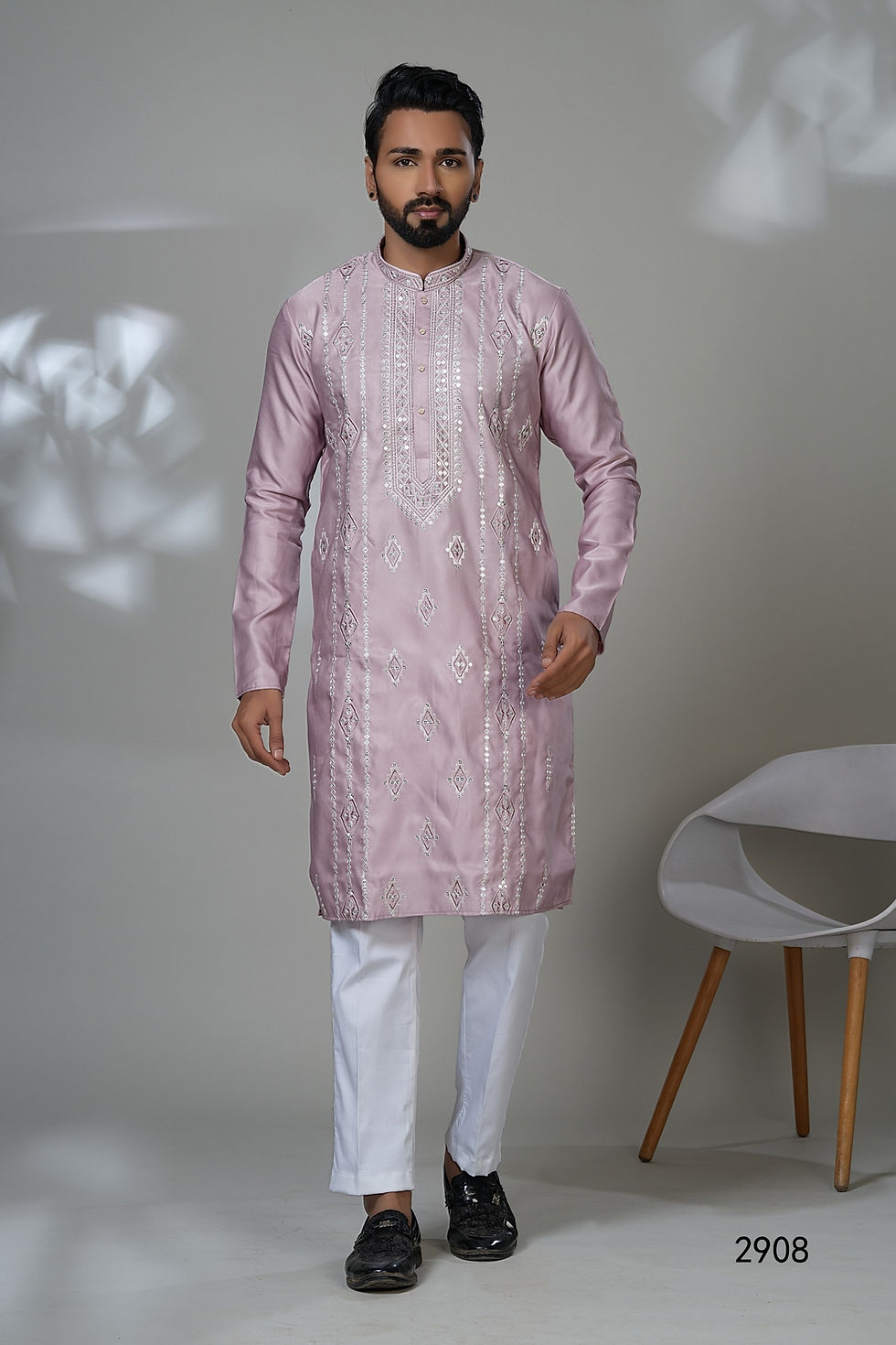 Man modeling a premium light purple kurta set for a wedding, featuring stunning silver embroidery and geometric mirror work