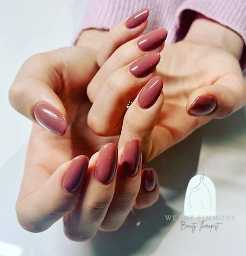 Hands with brown gel polish on nails