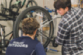 Auburn Outdoors bike tech with student