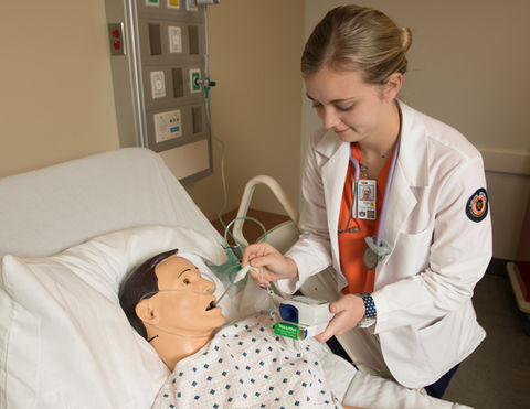 Nurse tending patient in the hospital. Simulation of health care AUCON.