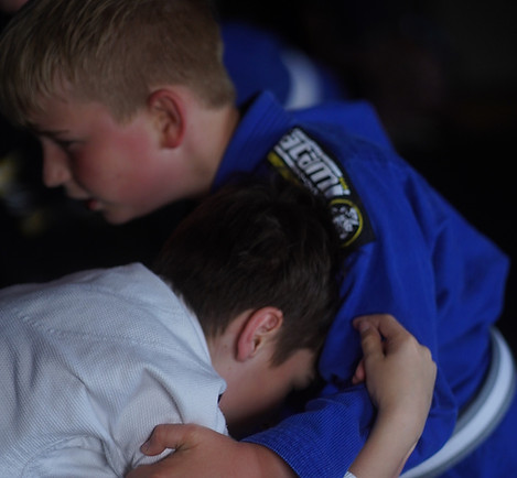 two teenagers grapple in bjj sparring session