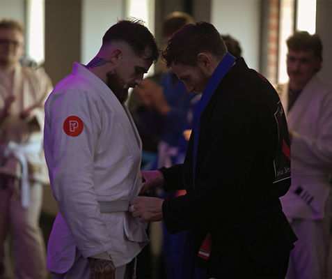 BJJ teacher gives stripe to student in BJJ class in Ashford, Kent