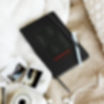 Hardcover lined notebook with elastic closure and ribbon marker, 80 cream-colored pages, compact 5.5 x 8.5 inch size, design