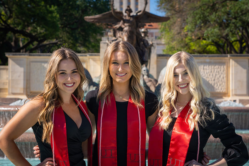 three UT Austin college grad girls in front of tower fountain