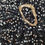 Thumbnail: Close-up of black sequin fabrick and gold buckle detail.