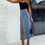 Thumbnail: Model wearing Denim button maxi skirt with front split and high waist fit, 90s inspired Summerlillys Coalville