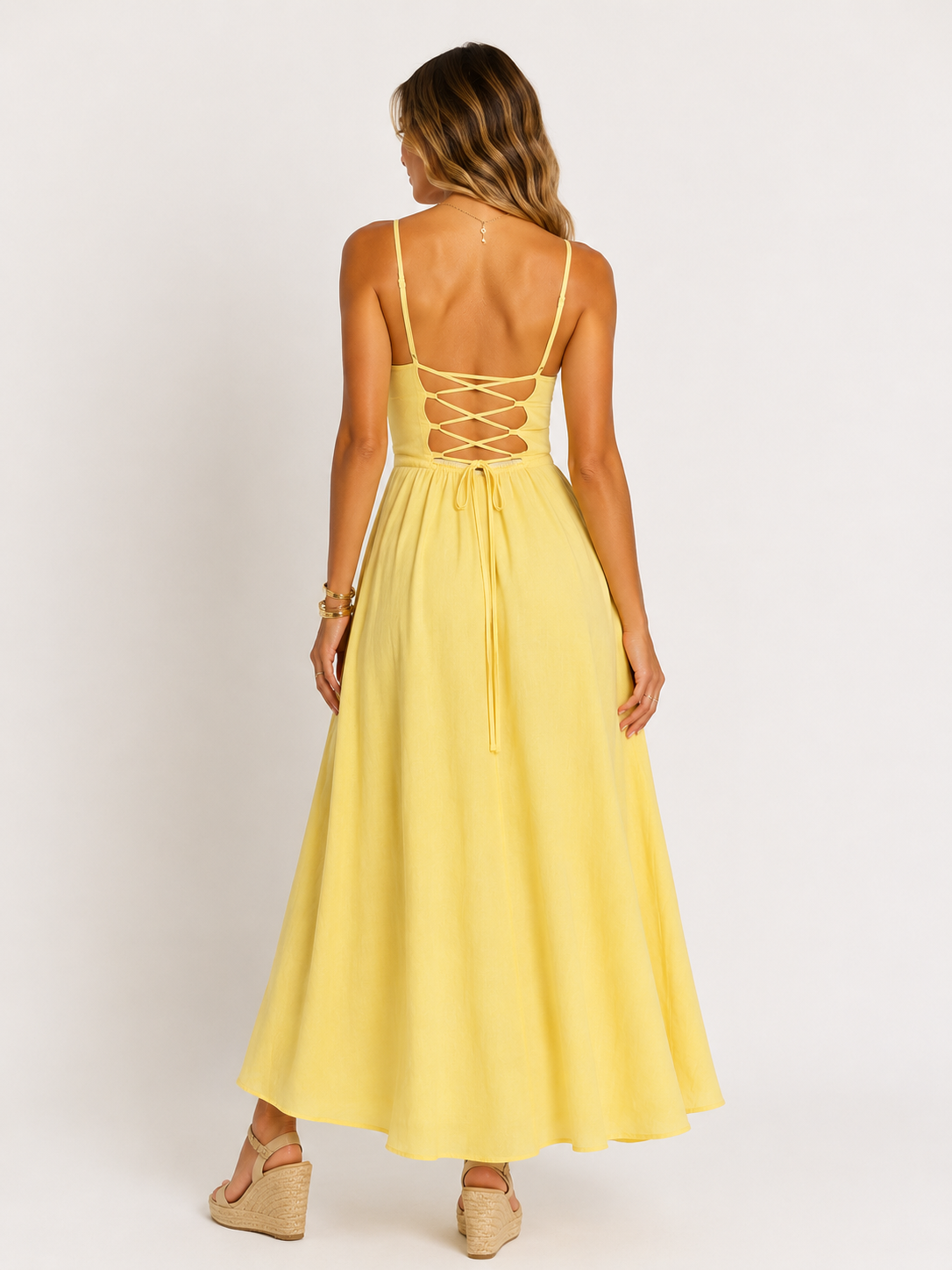 Back detail of yellow cotton maxi dress with lace up fastening and flowing full skirt