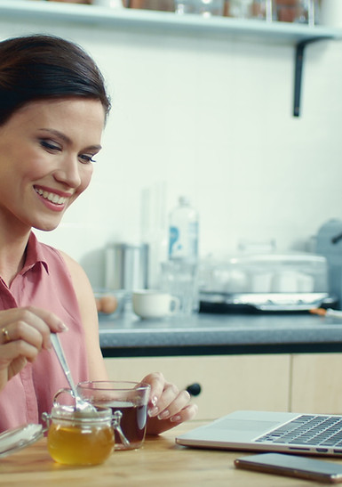 woman-using-laptop-video-call-online-girl-pouring-honey-into-cup-tea.jpg