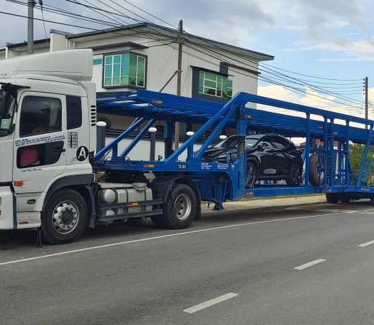Deeply reliable car carrier fleet executing flawless multi-car transport, safely securing commercial fleet vehicles for seamless domestic auto delivery bridging Miri and Bintulu.