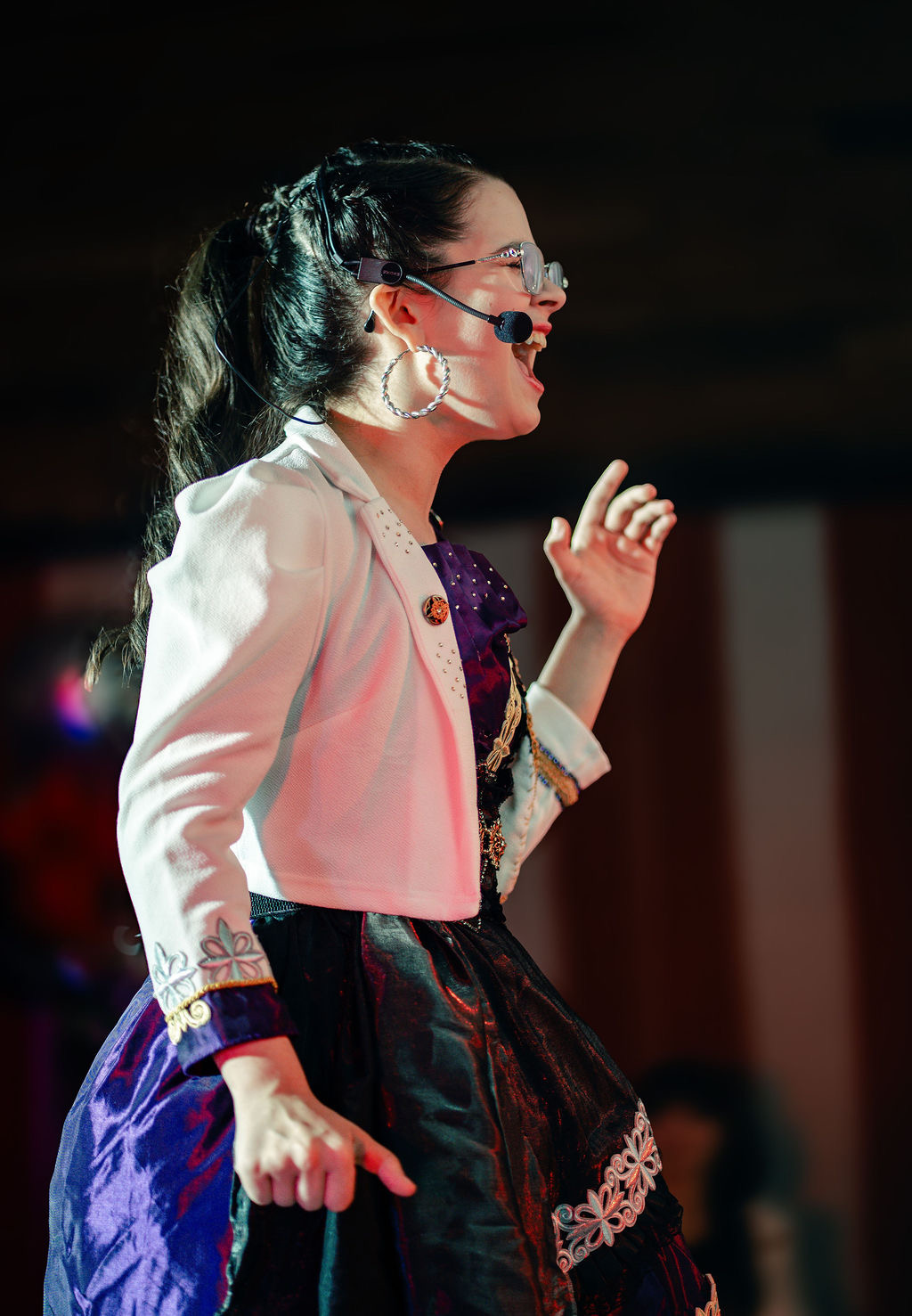 A singer performing on the Carnival of Couture stage