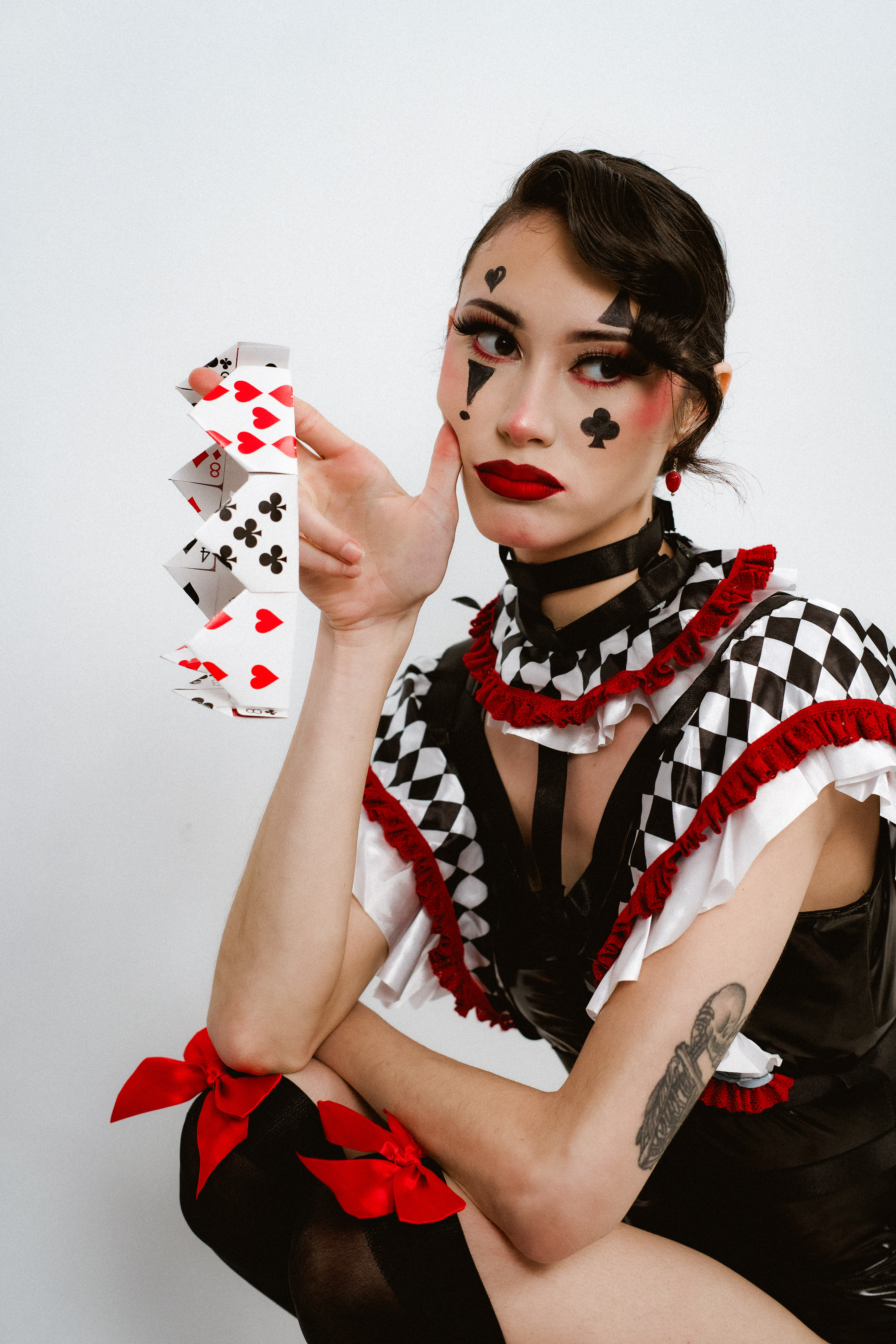 Creative portrait featuring red, black and white styling and playing cards