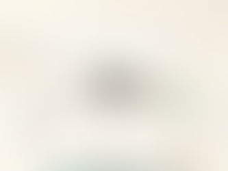 Minimal workspace with a clear desk in the foreground and blurred overlapping tasks in the background, representing fragmented attention and focus
