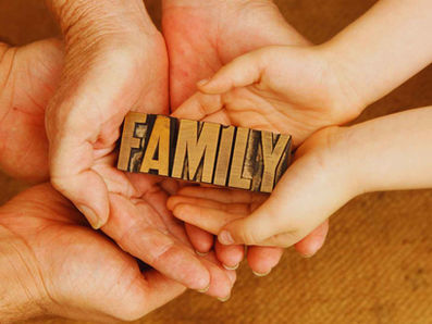 family members holding a sign "family"