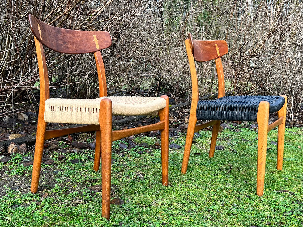 Two Hans Wegner Dining Chair 23s displayed outdoors, showcasing the craftsmanship of natural Danish cord on one and contrasting black cord on the other.