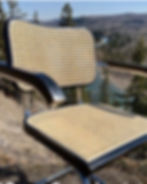 Black ebonized Cesca Armchair displayed in an outdoor setting with freshly installed cane by Caning Canada, Calgary, AB