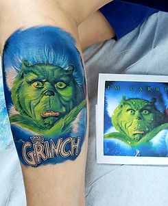 The Grinch colour realism tattoo done on leg by jessica jane tattoos in toronto
