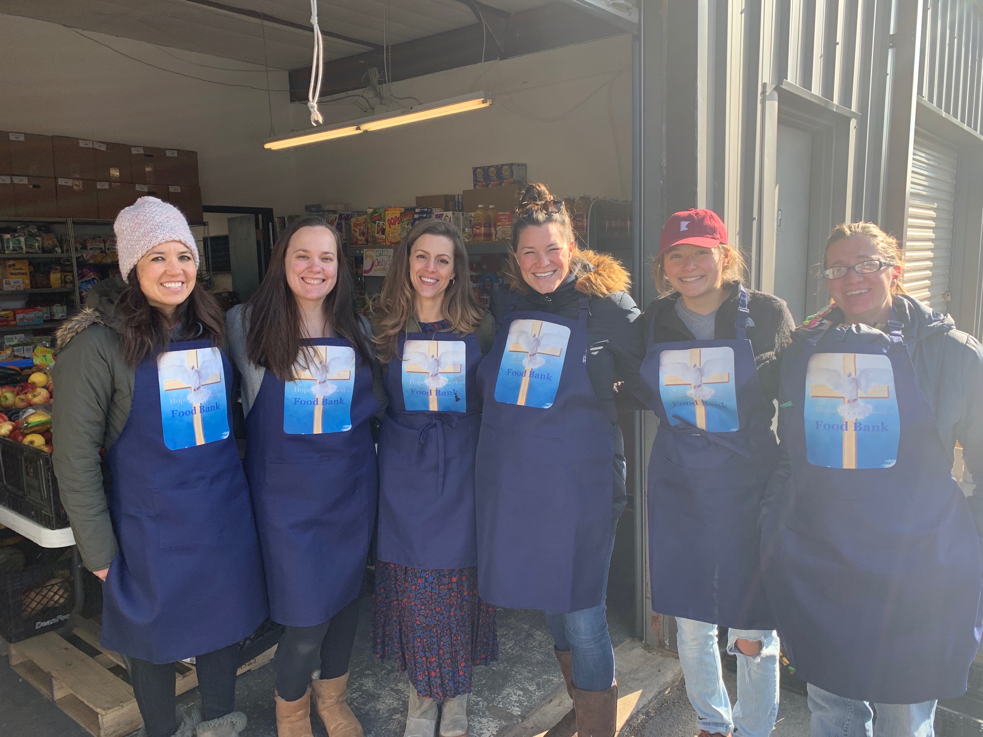 Hope’s Provision team members wearing food-bank aprons.