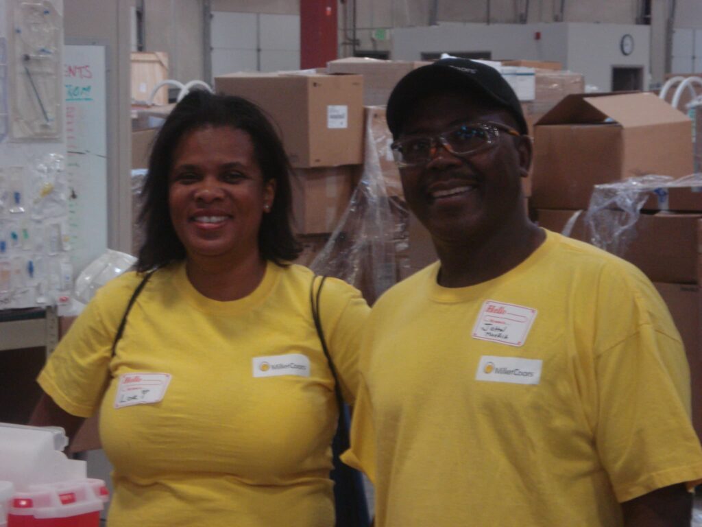 Lori Powell and John Muoria volunteering at Project C.U.R.E.’s Denver warehouse.