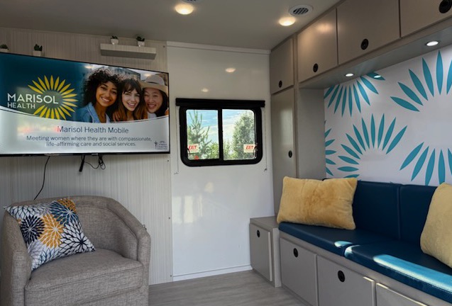 Seating and cabinetry inside the Marisol Health mobile clinic.