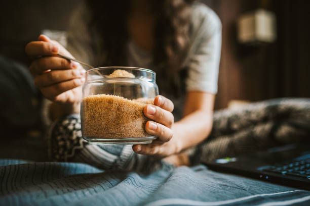 Young woman and a jar of sugar.