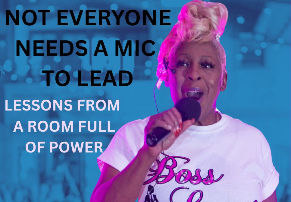 The image shows a woman with blonde hair holding a microphone.