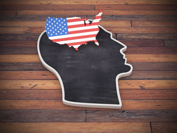 Silhouette of a head with a USA map in flag colors on top, set on wooden background. The mood is introspective and patriotic.