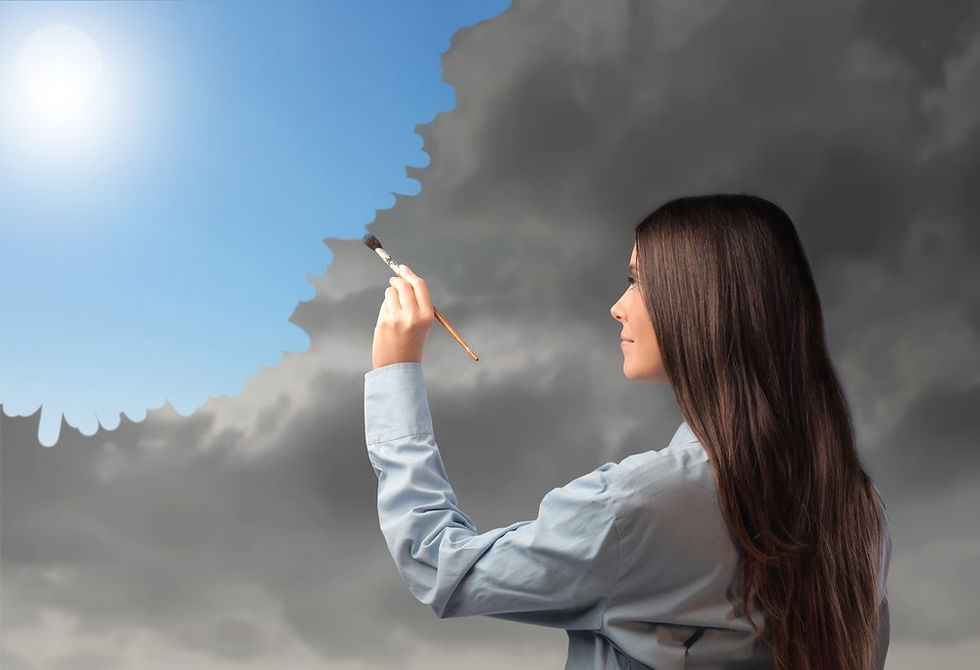 Woman in blue shirt paints gray clouds into a blue sky with a brush, symbolizing change and creativity. Bright sunlight in the corner.