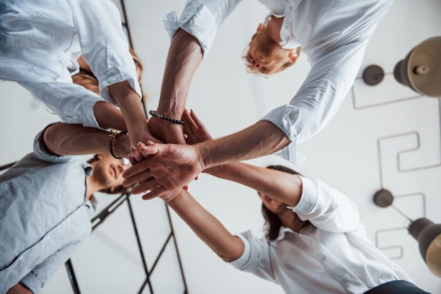 successful business people putting their hands together