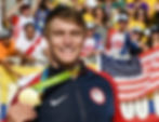 Photo of Connor Fields holding an Olympic medal.