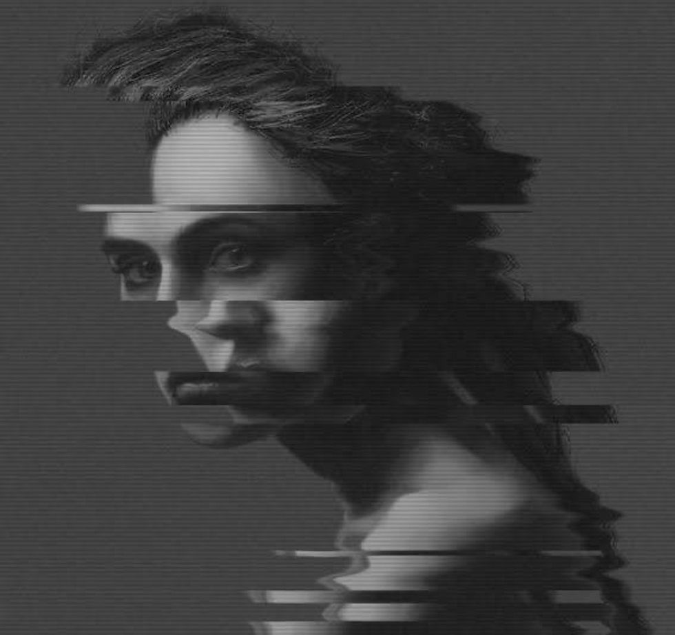 Distorted grayscale portrait of a person with glitch effects across the face, creating an abstract and mysterious mood.