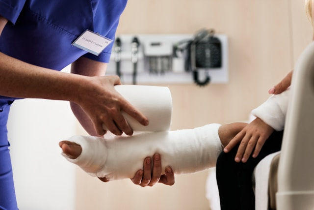girl with broken leg in plaster cast