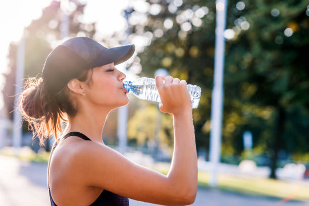 Photo of young woman drinking water