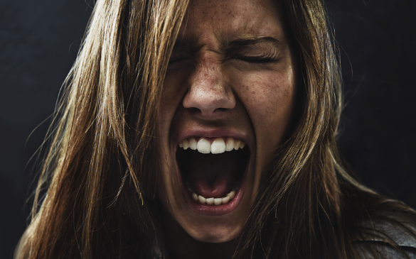 a woman shouting with her mouth open