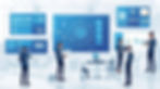 Professionals in a modern office discuss data charts on large blue screens labeled AI. The setting is bright and tech-focused.