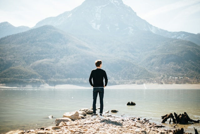 person standing on mountain with horizon