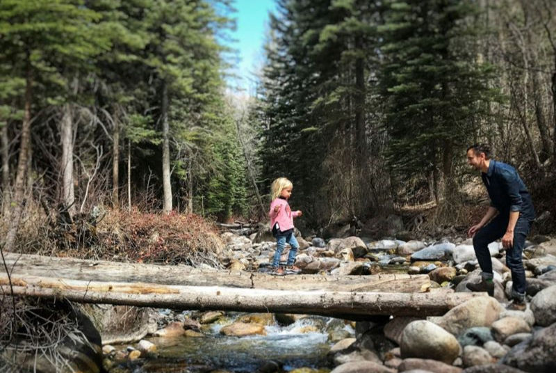 Father and daughter crossing the river