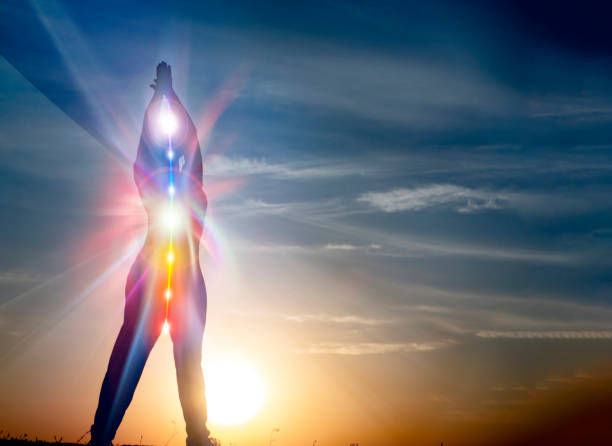 Silhouette of woman in yoga pose on beach sunset view