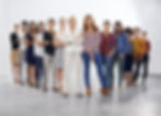 The photo features a diverse group of women standing confidently in a modern, neutral space, showcasing a range of professional attire and expressions.