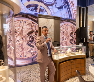 Man speaking to a group in a jewelry store