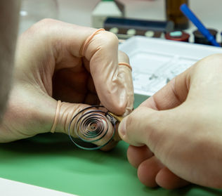 Watchmaker repairing a delicate spring