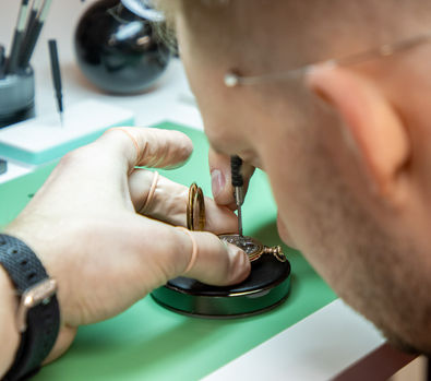 Watch repair technician working on a watch